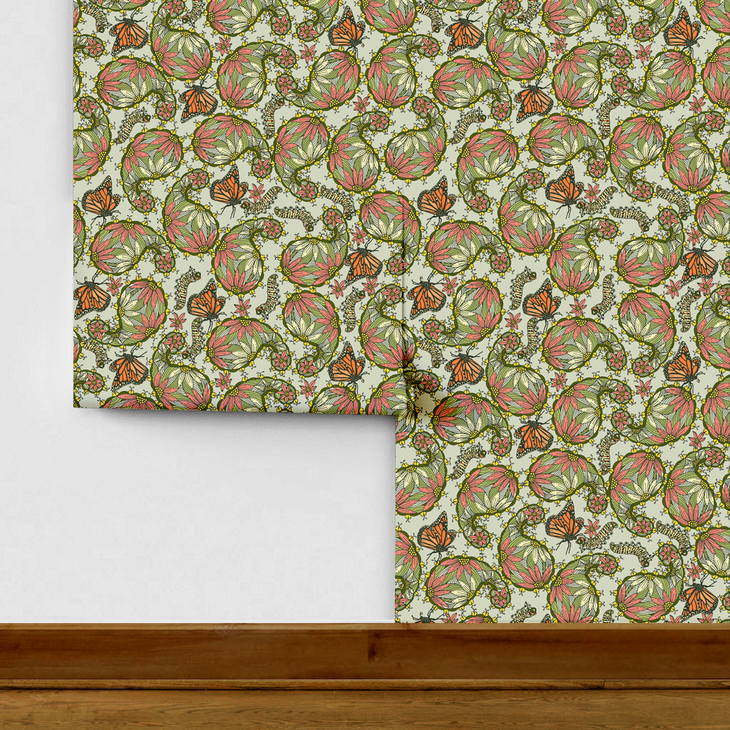 The artwork features a dense, seamless pattern composed of intricately detailed butterflies, caterpillars, and flowers. The butterflies are primarily orange with black and white accents, conveying a monarch butterfly design. The caterpillars are segmented and textured with earthy tones of green and beige, blending naturally with the floral elements. The flowers have petals colored in shades of pale pink and green, with leaves interspersed throughout the composition. The background is a light, muted yellow, which enhances the vibrant colors of the butterflies and floral motifs. The overall design is highly decorative and organic, showcasing a lyrical interplay between the stages of a butterfly's life cycle and plant life.